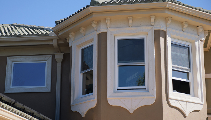 Double hung vinyl windows on bay window exterior