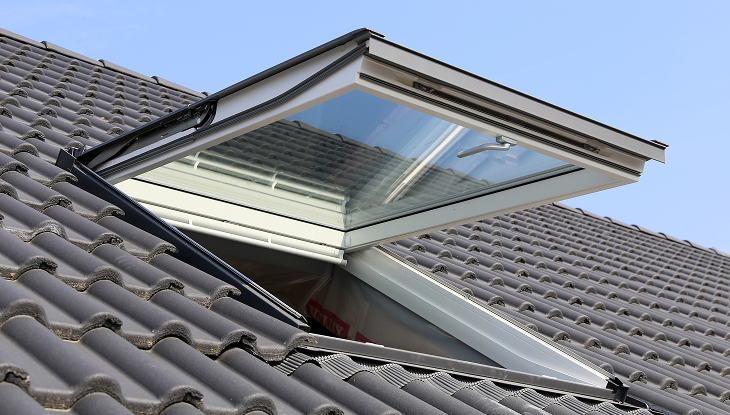 Open skylight vinyl window on tiled roof